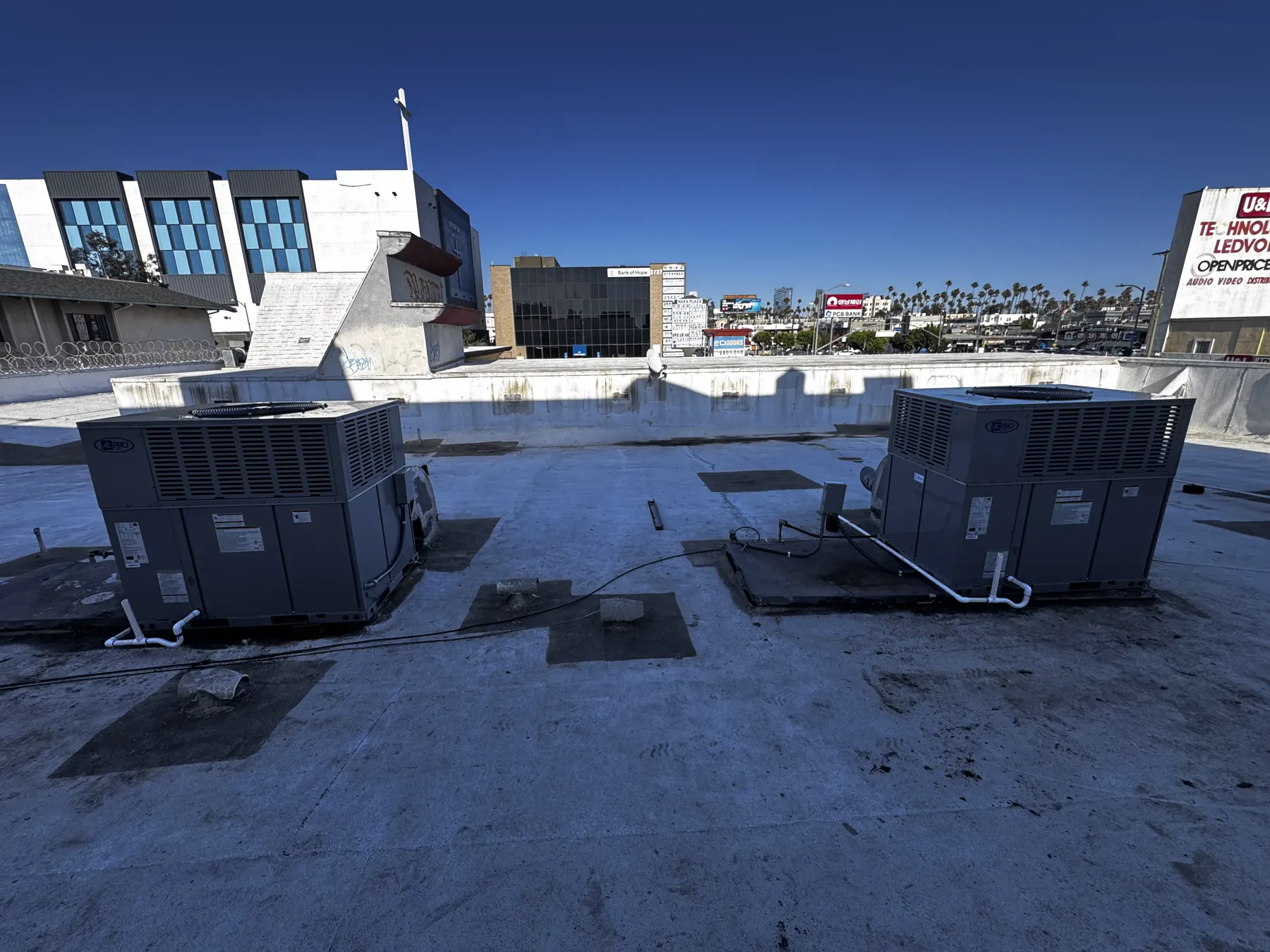 Commercial rooftop HVAC units photographed at a Quality Temp jobsite