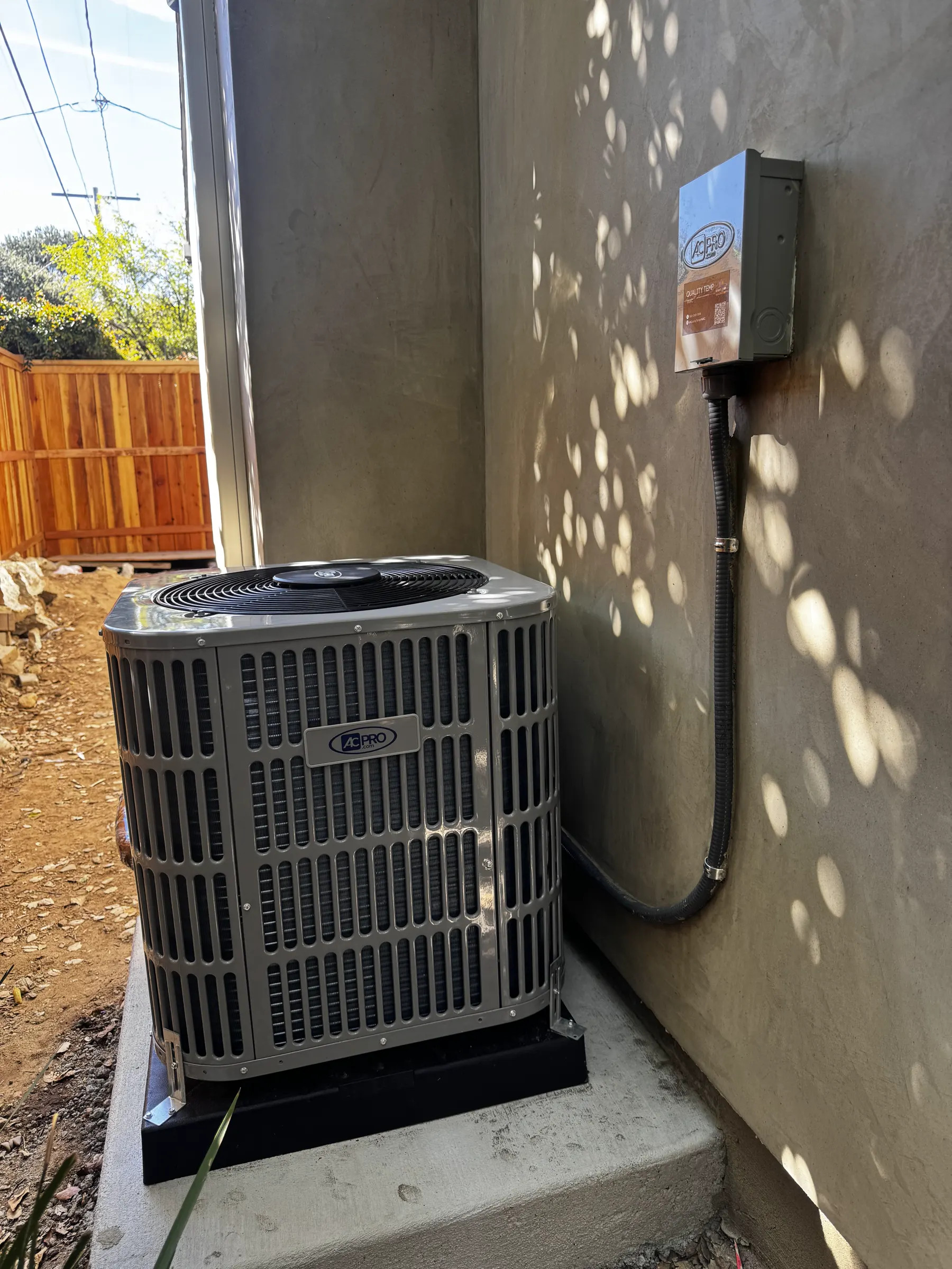 Outdoor HVAC condenser beside a residential building