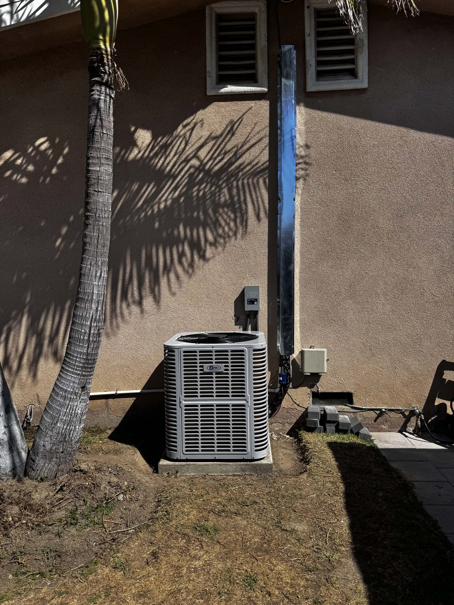 Outdoor HVAC condenser equipment beside a residential property